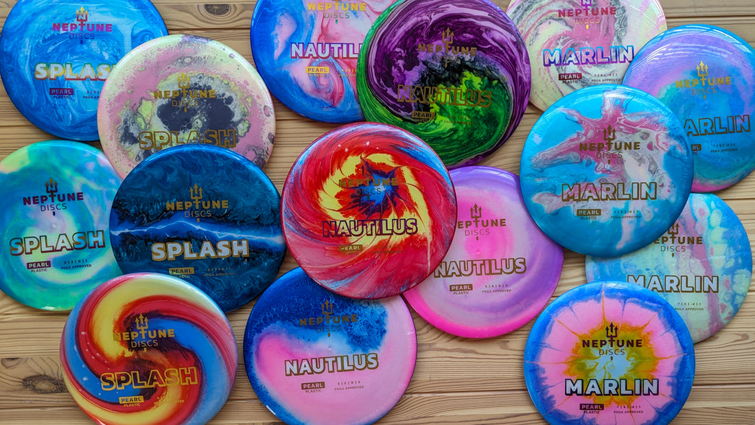 15 uniquely dyed disc golf discs on a table